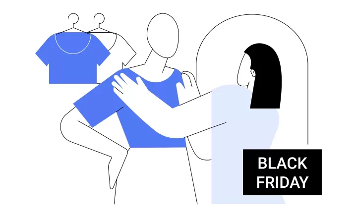 Egy hölgy felpróbál egy elegáns kardigánt egy ruhaüzletben Black Friday akció idején. 